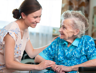 senior care nurse tends to elderly woman in southeast michigan