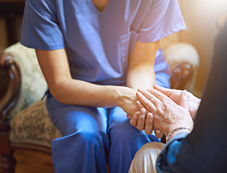 senior care nurse holds elderly hands in Ann Arbor MI